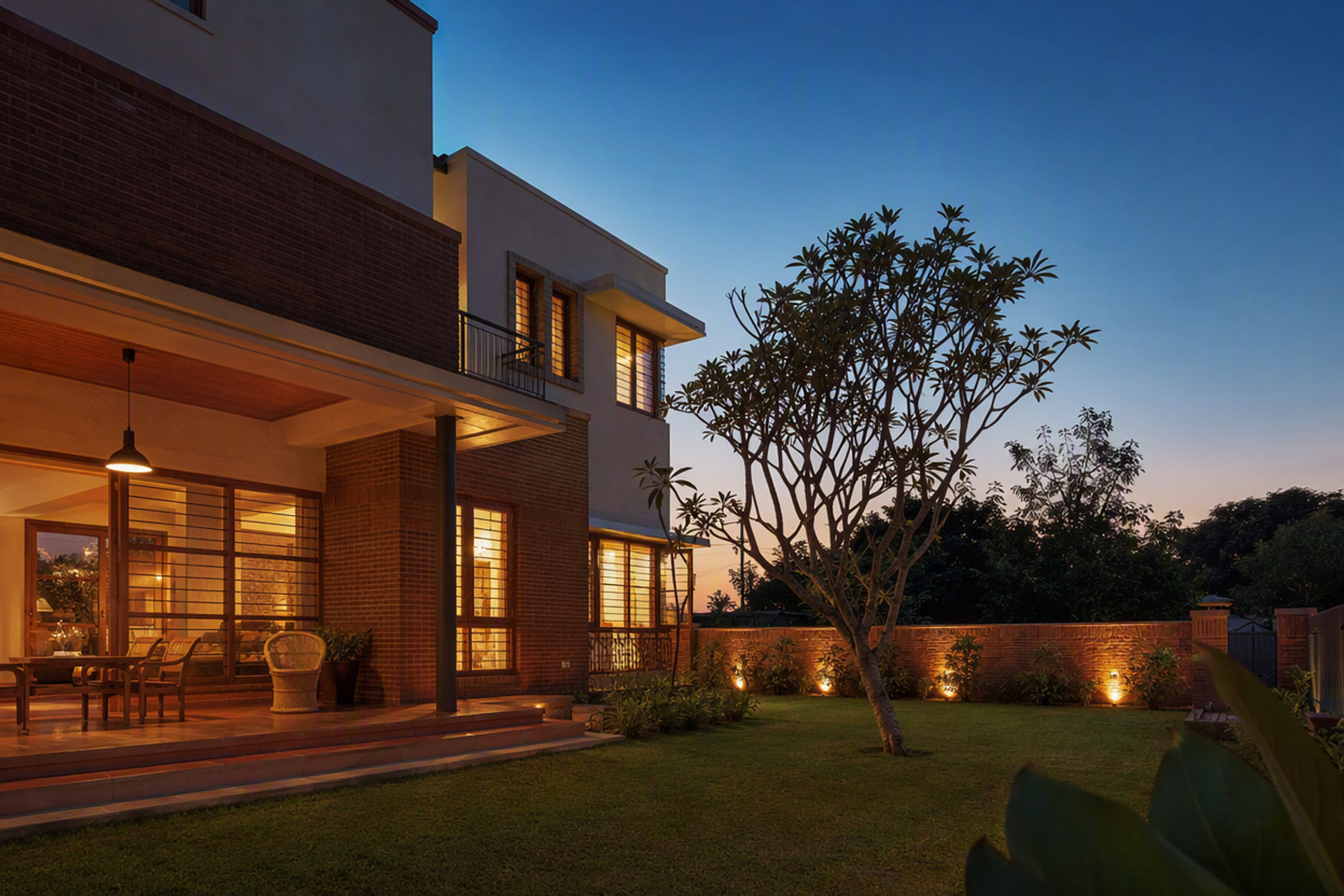 A finished house at dusk seen from the garden